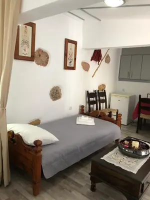 a bedroom with a bed and a table in a room at Little cottage in Athens
