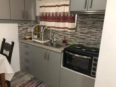 a kitchen with a sink and a microwave at Little cottage in Athens