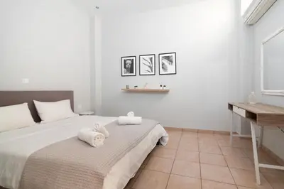 a bedroom with a bed with towels on it at Spacious apartment-600m from the subway in Athens