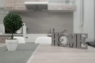 a clock sitting on top of a table at Spacious apartment-600m from the subway in Athens