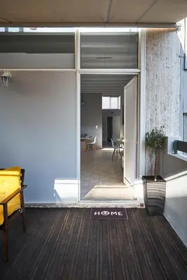 an open door to a room with a table and chairs at Spacious apartment-600m from the subway in Athens