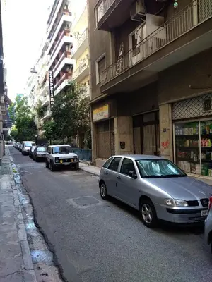 a silver car parked on the side of a city street at Yiannis Kalimarmaro Studio,Athens Center in Athens