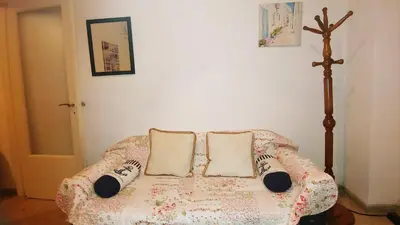 a couch in a room with two pillows on it at Yiannis Kalimarmaro Studio,Athens Center in Athens