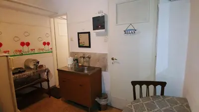 a small bathroom with a sink and a desk at Yiannis Kalimarmaro Studio,Athens Center in Athens