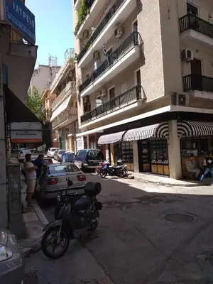 a motorcycle parked on the side of a city street at Yiannis Kalimarmaro Studio,Athens Center in Athens