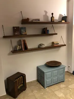 a room with a table and shelves on the wall at Feels like home with luxury details in Athens