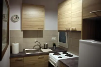 a small kitchen with a sink and a stove at Feels like home with luxury details in Athens