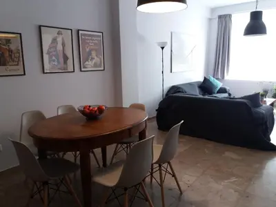 a living room with a table and a bed at Feels like home with luxury details in Athens