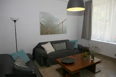 a living room with a couch and a table at Feels like home with luxury details in Athens