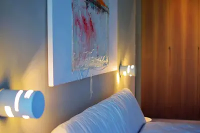 a bedroom with a couch and a painting on the wall at 101 Adrianou Apartments in Athens