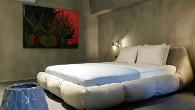 a bedroom with a bed with a couch in it at 101 Adrianou Apartments in Athens