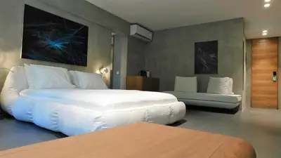 a bedroom with a large white bed and a couch at 101 Adrianou Apartments in Athens