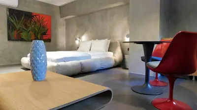 a room with a bed and a vase on a table at 101 Adrianou Apartments in Athens