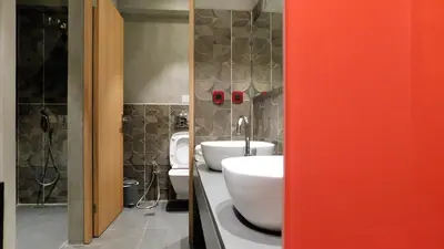 a bathroom with two sinks and two toilets at 101 Adrianou Apartments in Athens