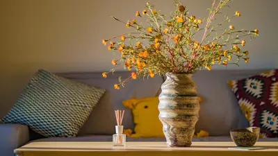 a vase with flowers sitting on a table at Best Seaview Attica in Saronida