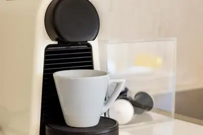a coffee cup sitting on top of a coffee maker at Best Seaview Attica in Saronida