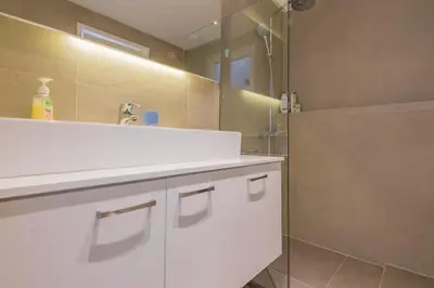 a bathroom with a white sink and a mirror at Best Seaview Attica in Saronida