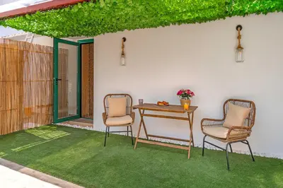 a patio with two chairs and a table at Cool Style Private Apartments in Athens
