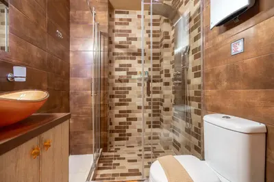 a bathroom with a toilet and a glass shower at Cool Style Private Apartments in Athens