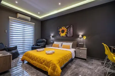 a bedroom with a yellow bed and a chair at Cool Style Private Apartments in Athens