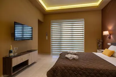 a bedroom with a large bed and a large window at Cool Style Private Apartments in Athens