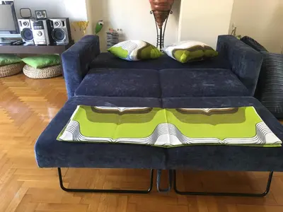 a blue couch with a blanket on top of it at Annadel Flat in Athens