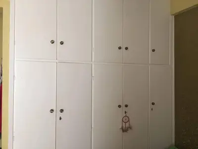 a bunch of white cabinets in a room at Annadel Flat in Athens