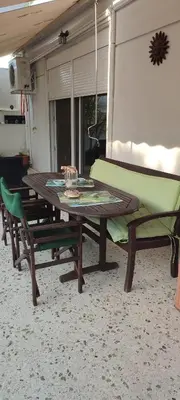 a picnic table and chairs in a living room at Annadel Flat in Athens
