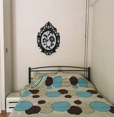a bedroom with a bed and a mirror on the wall at Annadel Flat in Athens