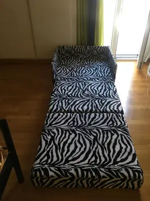 a zebra print couch in a living room at Annadel Flat in Athens