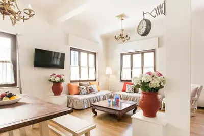 a living room with a couch and a table at Vintage Charm by the Acropolis! in Athens