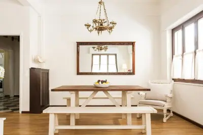 a dining room with a table and a mirror at Vintage Charm by the Acropolis! in Athens