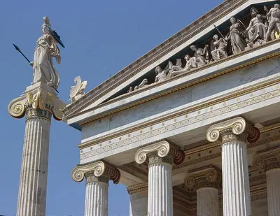 a building with a statue on top of it at Vintage Charm by the Acropolis! in Athens