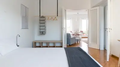 a bedroom with a large white bed in a room at Ariadne's Penthouse in Central Athens in Athens