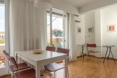 a dining room with a white table and chairs at Ariadne's Penthouse in Central Athens in Athens