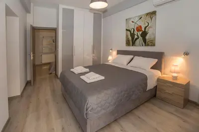 a bedroom with a large bed with two towels on it at Acropolis Gem by GHH in Athens