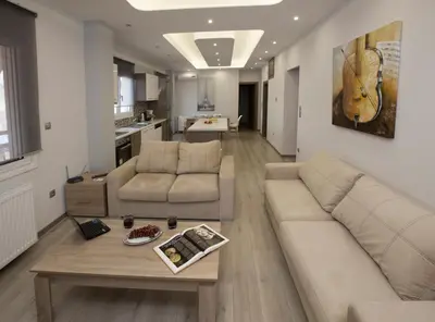 a living room with a couch and a coffee table at Acropolis Gem by GHH in Athens