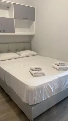 a bed with white sheets and towels on it at Acropolis Gem by GHH in Athens