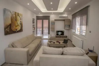 a living room with a couch and a table at Acropolis Gem by GHH in Athens