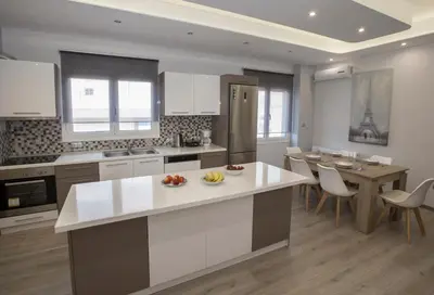 a kitchen with a island in the middle of a room at Acropolis Gem by GHH in Athens