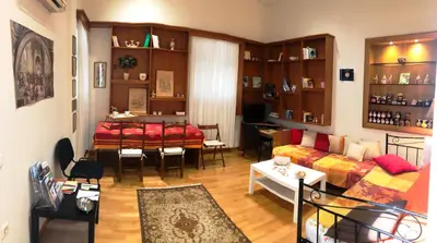 a living room with a couch and a dining room at Stately central apartment in Athens