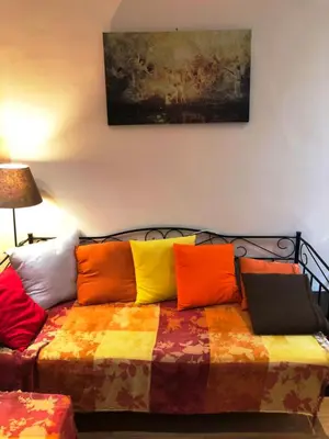 a bed with colorful pillows on it in a room at Stately central apartment in Athens