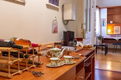 a kitchen with a counter with a bunch of food and drinks at Stately central apartment in Athens