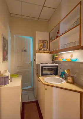 a kitchen with a sink and a microwave at Stately central apartment in Athens