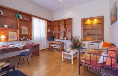 a living room with a bed and a desk at Stately central apartment in Athens
