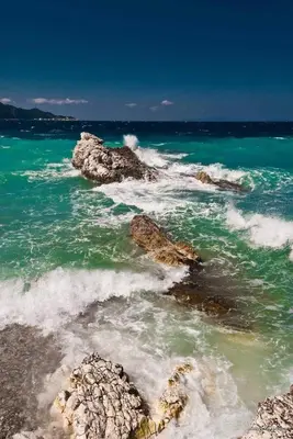 a view of the ocean with rocks in the water at Seaside House in Voula in Athens