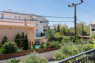 a view of a garden from the balcony of a building at Seaside House in Voula in Athens
