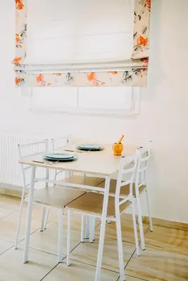 a white dining room table with two chairs and a window at Best House, Rooftop Aprtm., Marina Zeas Piraeus in Piraeus