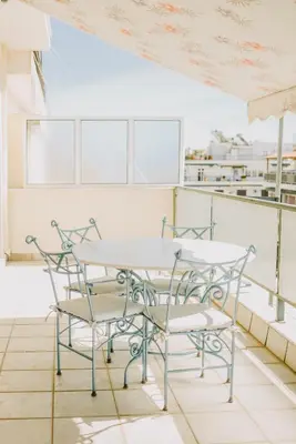 a table and chairs on top of a building at Best House, Rooftop Aprtm., Marina Zeas Piraeus in Piraeus