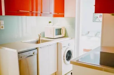 a kitchen with a washing machine and a microwave at Best House, Rooftop Aprtm., Marina Zeas Piraeus in Piraeus